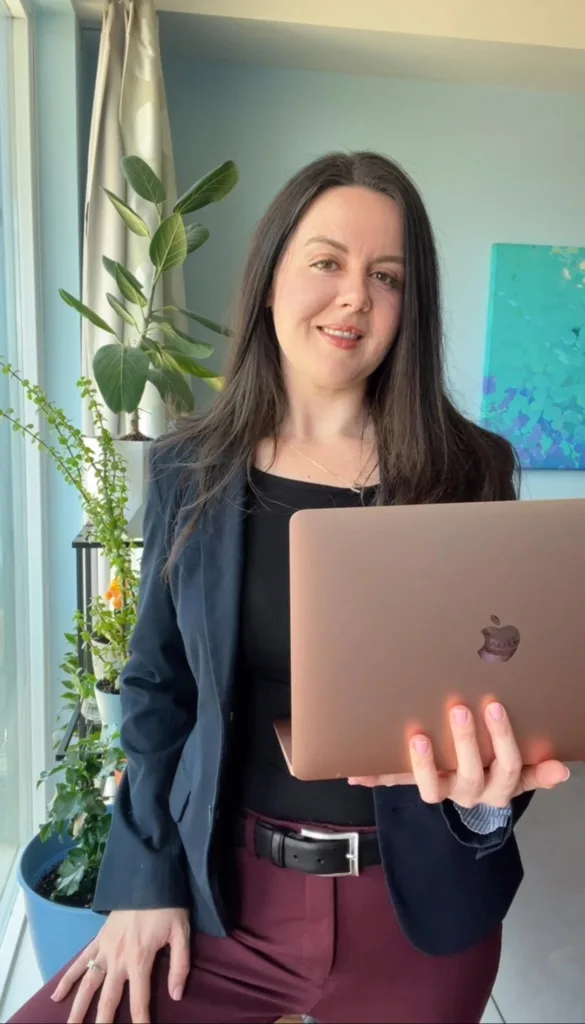 Registered Dietitian Leeauna Duchesne holding a laptop