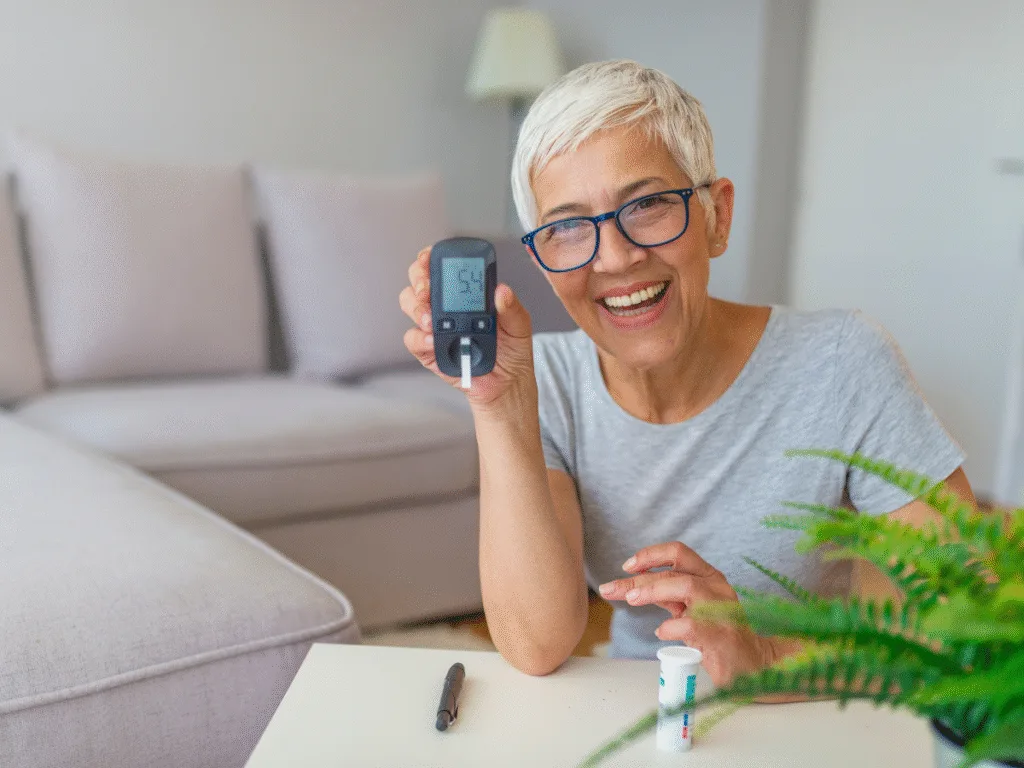 elderly lady showing her blood glucose monitor after trying the diabetic diet 