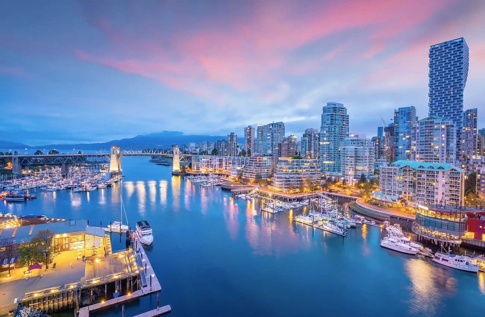 vancouver british columbia harbour skyline with pink sunset clouds