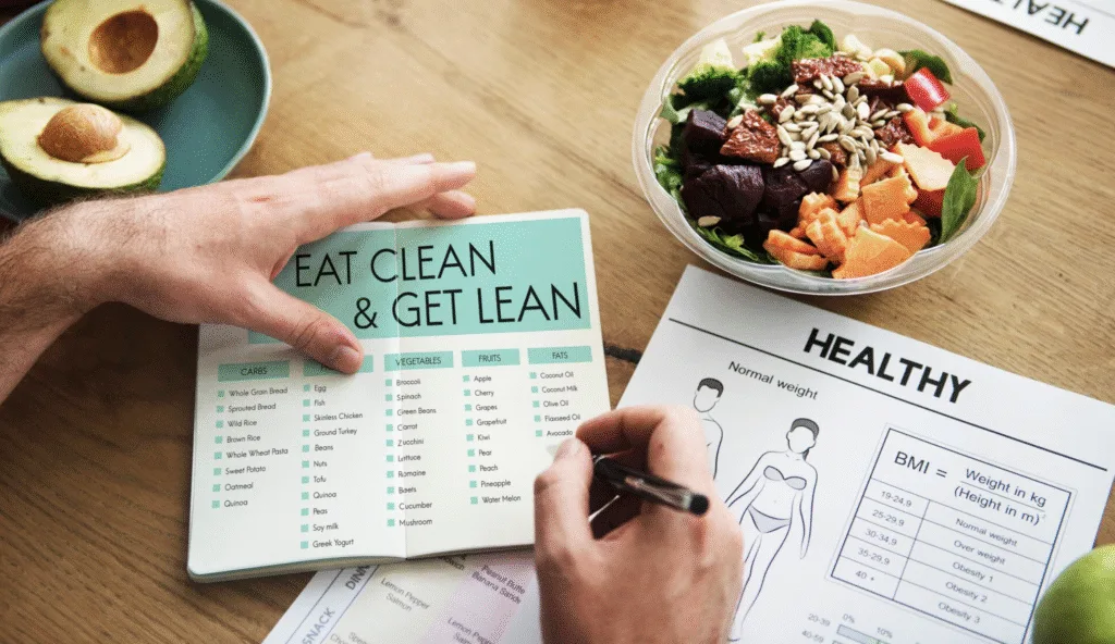 writing up a sample menu of what healthy food nearby looks like. an avocado and salad are on the table