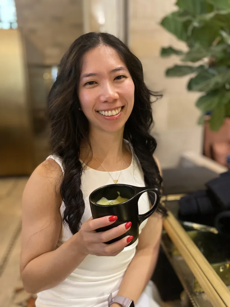 Registered Dietitian Helen Tieu sipping a matcha latte at a cafe