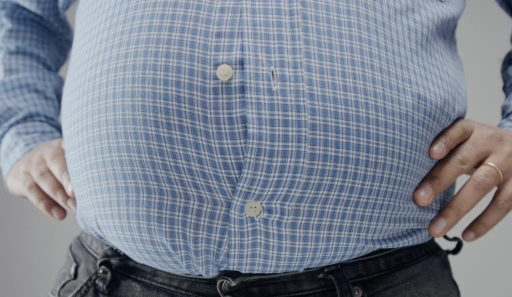 Bloated stomach and abdominal discomfort, illustrating digestive issues and the need to increase fiber gradually