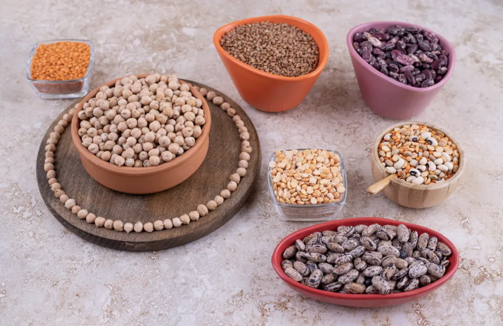 Bowls of lentils, chickpeas, beans, and split peas, highlighting high-fiber foods for weight loss and healthy eating