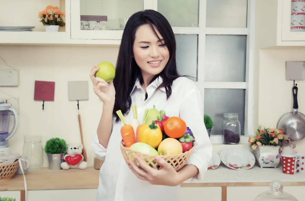 registered dietitian holding a fruit basket standing in a kitchen in richmond