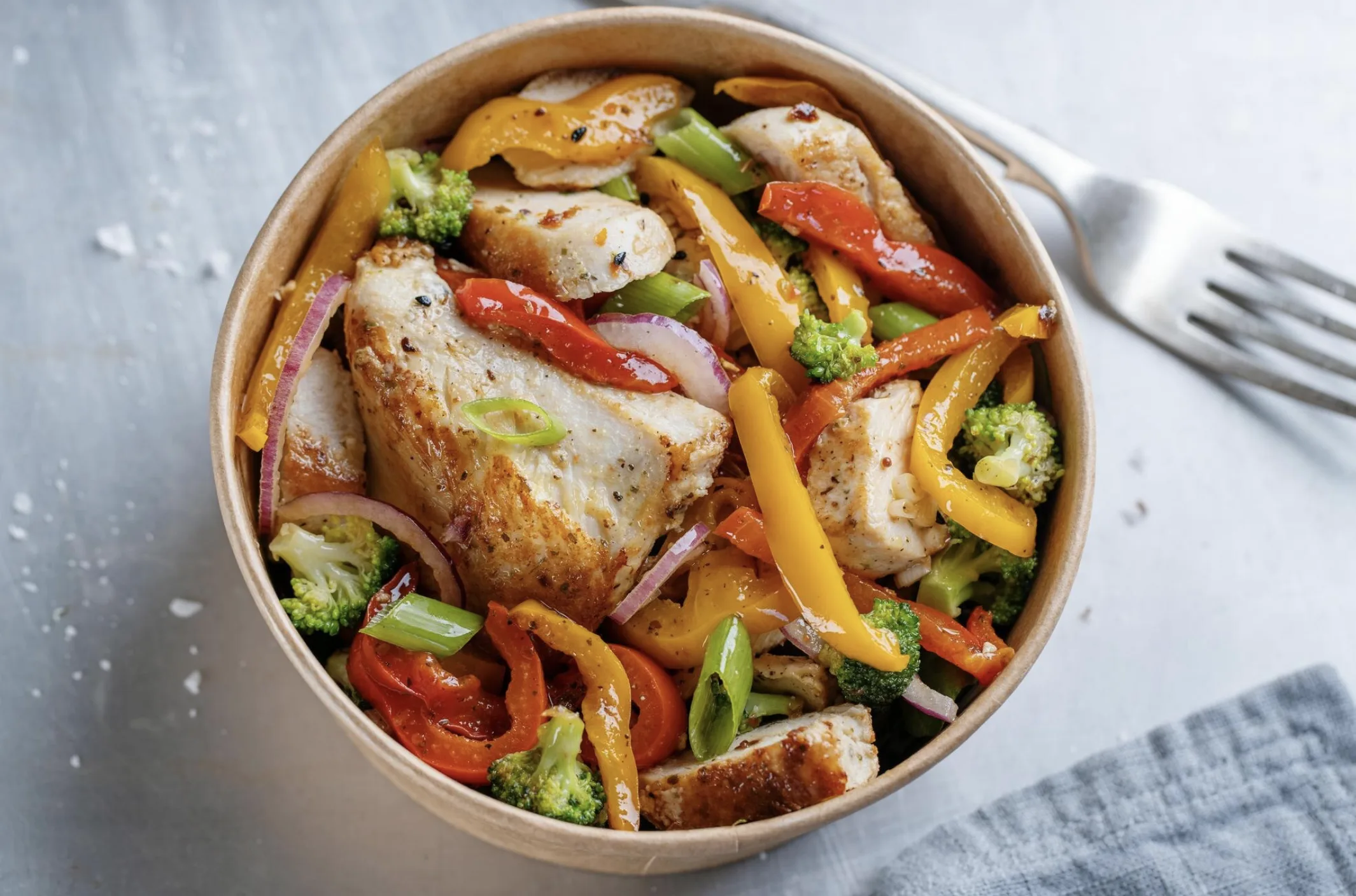 Chicken, rice and cooked vegetables in a balanced lunch bowl