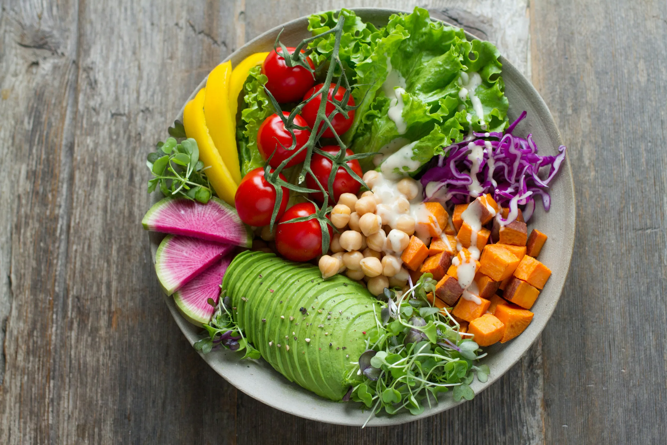 Colourful bowl with chickpeas, avocado, sweet potato and vegetables