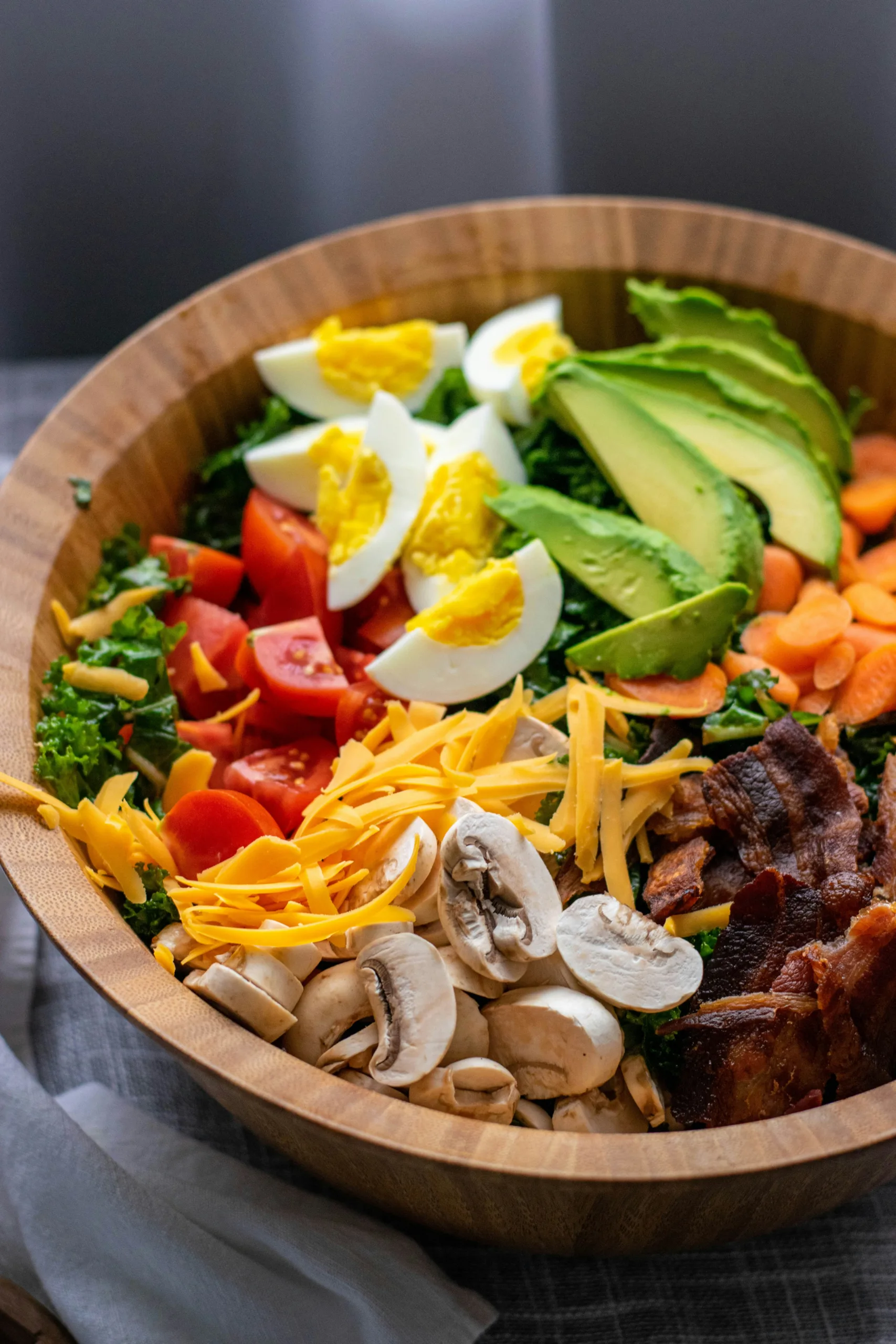 Salad bowl with eggs, avocado, tomatoes and leafy greens