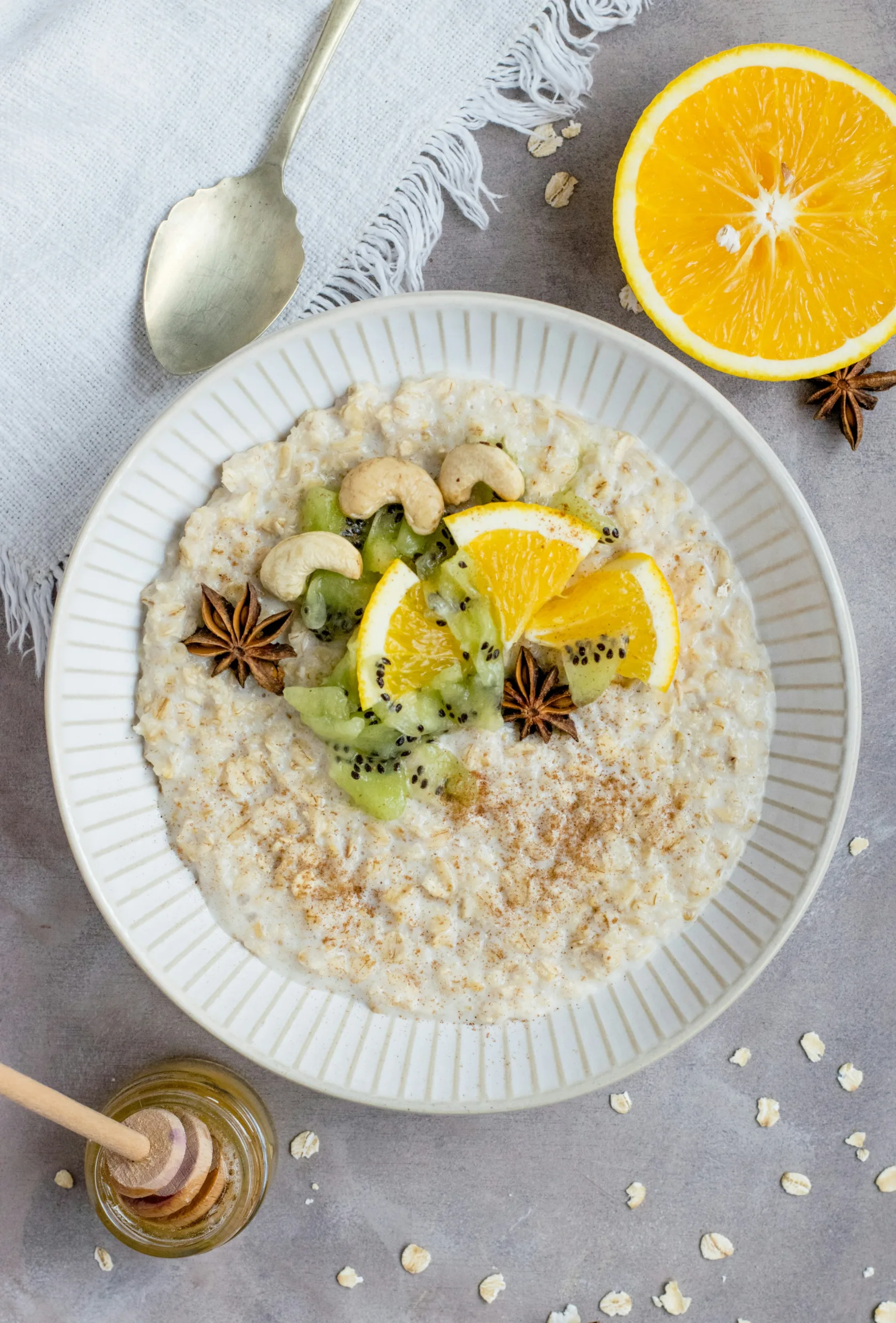 Porridge topped with kiwi, orange slices and cashews